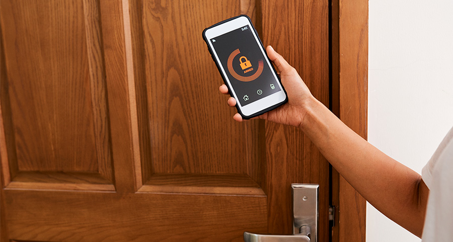 Person using app on phone to lock door.